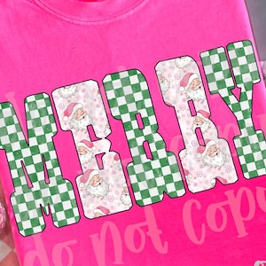 May include: A bright pink t-shirt with the words "MERRY BABY" in a green and white checkered pattern and Santa Claus faces. The text "do not copy" is below the main text. The shirt is a Comfort Colors brand.