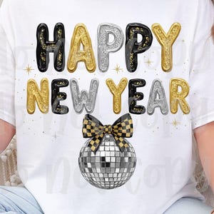 May include: White t-shirt featuring the text "HAPPY NEW YEAR" in black, gold, and silver bubble letters. A disco ball with a black and gold bow is below the text. The design is a festive choice for New Year's celebrations.