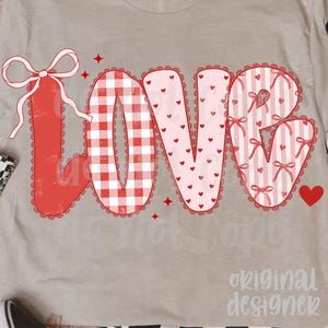 May include: A beige t-shirt with the word "LOVE" in a red and pink design. The "L" is a red bow, the "O" is a red and white gingham pattern, the "V" is pink with hearts, and the "E" is pink with bows. The shirt has the text "original designer".