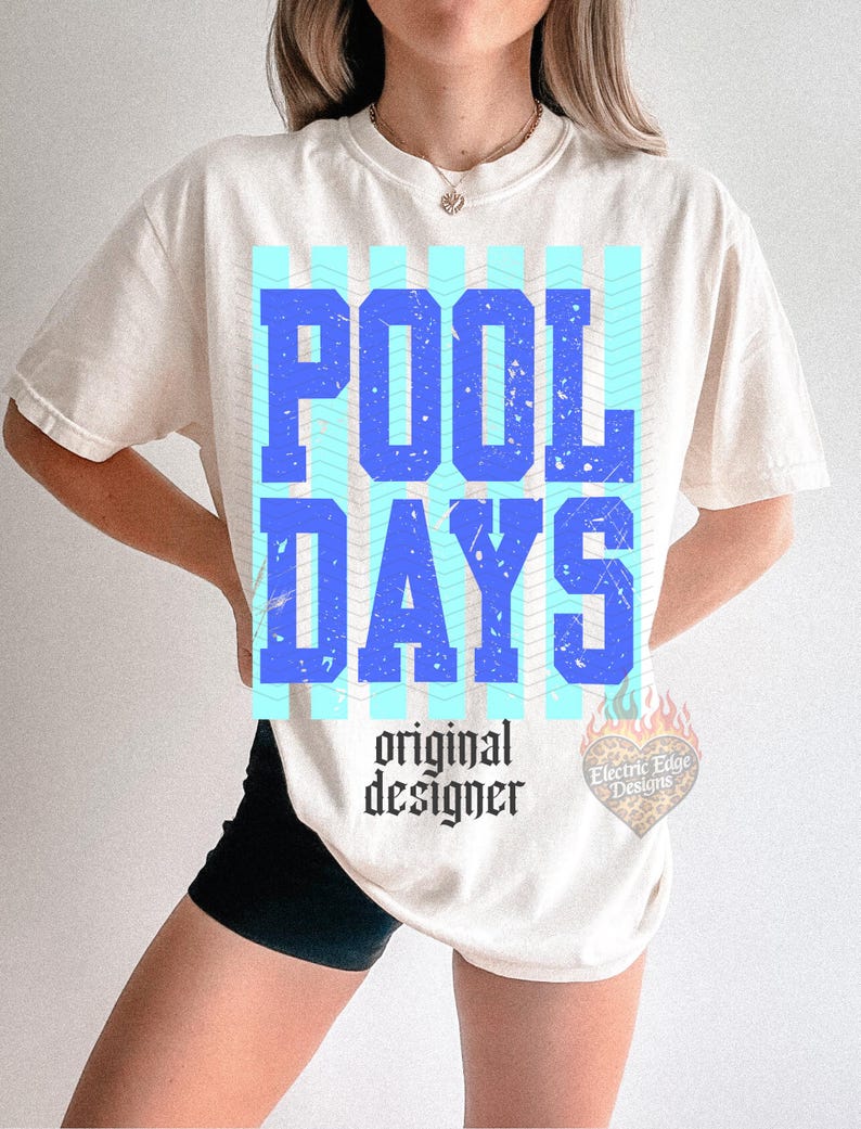 May include: Cream-coloured t-shirt featuring the words "POOL DAYS" in large blue letters, set against a light blue wavy pattern. The text "original designer" is below in a gothic font.