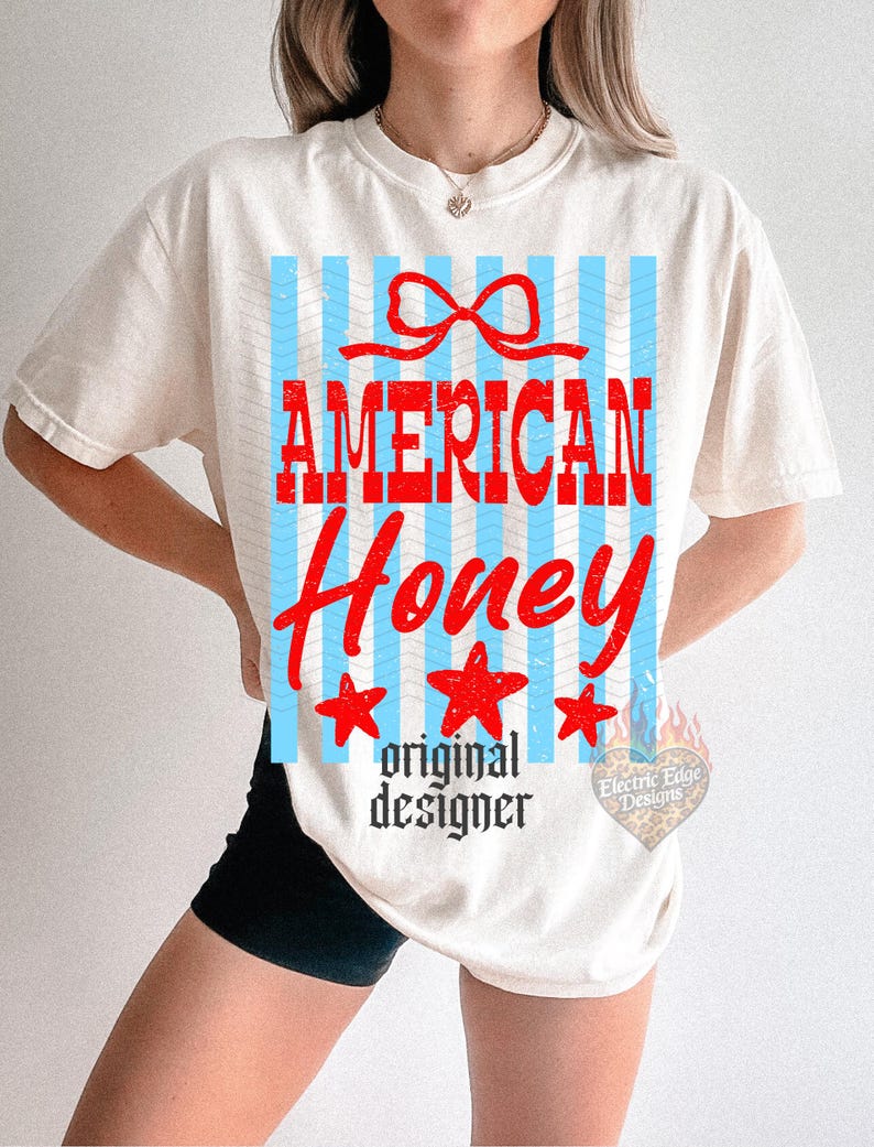 May include: Cream-colored t-shirt with a graphic design featuring the words "AMERICAN Honey" in red, with blue vertical stripes and red stars. The text "original designer" is below the main text.