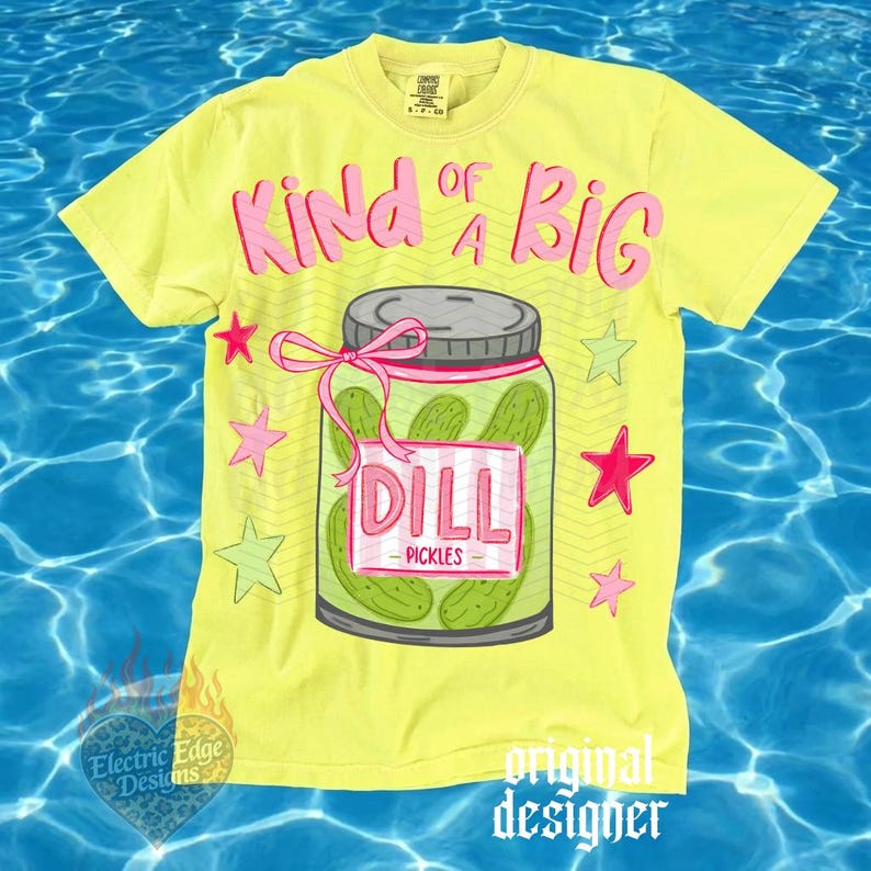 May include: Yellow t-shirt with a graphic of a pickle jar that says "Kind of a Big Dill". The jar is filled with pickles and has a pink bow. Pink and green stars surround the jar. The shirt has the words "original designer" on the bottom.