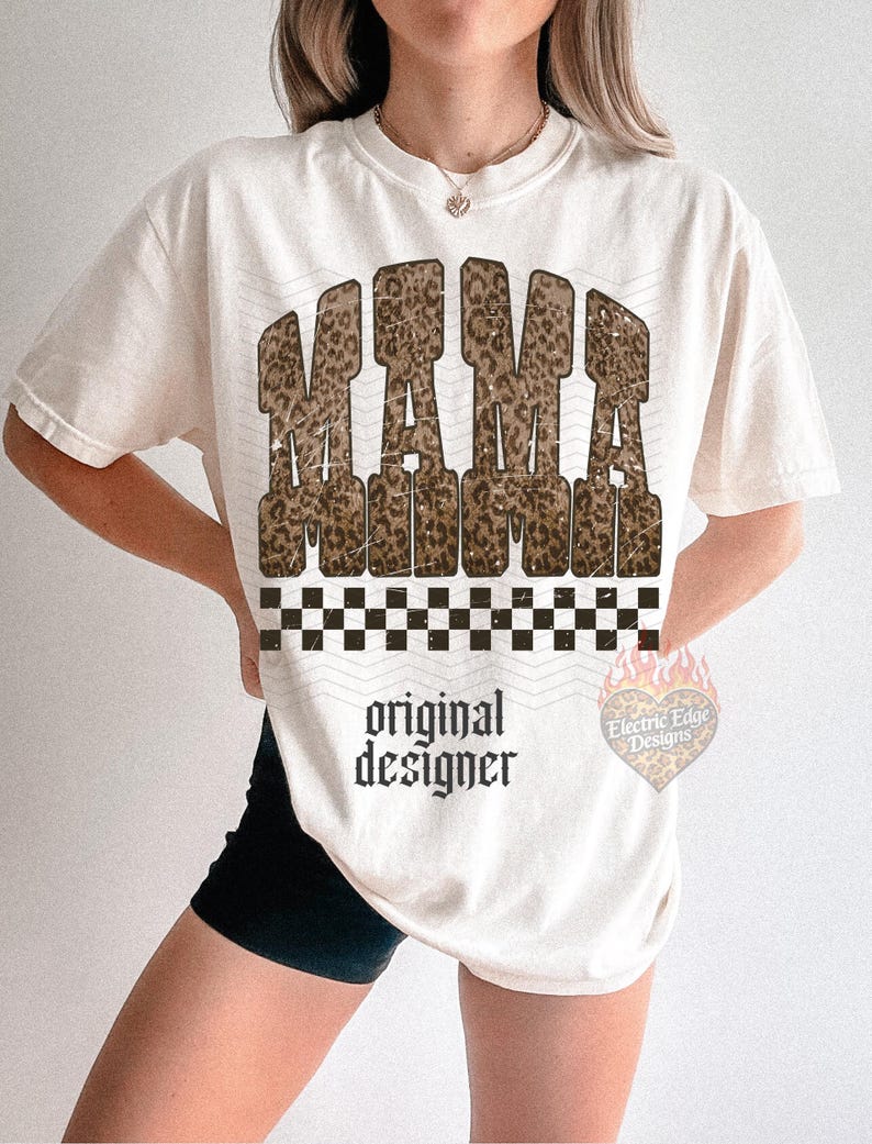 May include: Cream-colored t-shirt with the word "MAMA" in a leopard print design. Below the word "MAMA" is a black and white checkered pattern. The words "original designer" are printed below the checkered pattern.