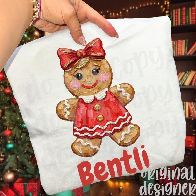 May include: White pillow with a gingerbread girl design. The gingerbread girl has a red dress, bow, and rosy cheeks. The text "Bentli" is in red at the bottom. The words "original designer" are also visible.