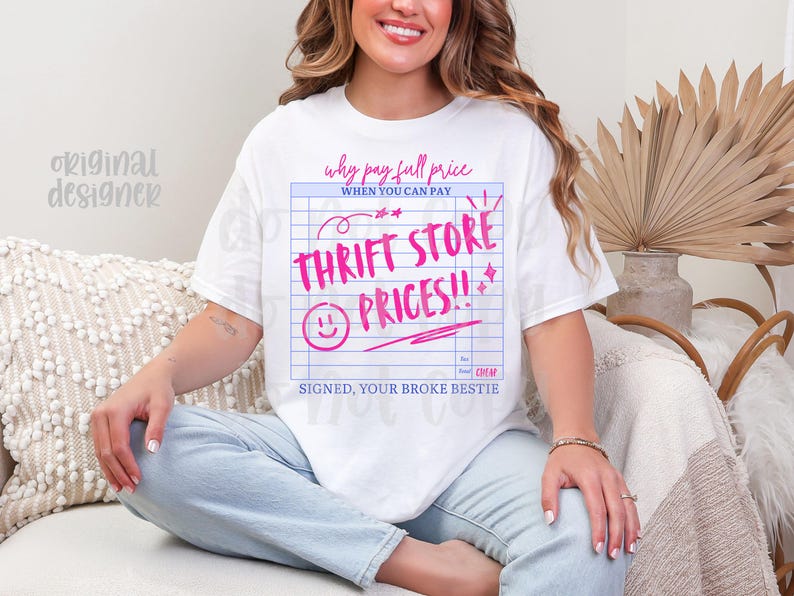 May include: White t-shirt with a pink graphic that reads "Why pay full price when you can pay Thrift Store Prices!!" in a ledger-style design. The shirt also includes a smiley face and the text "Signed, your broke bestie."