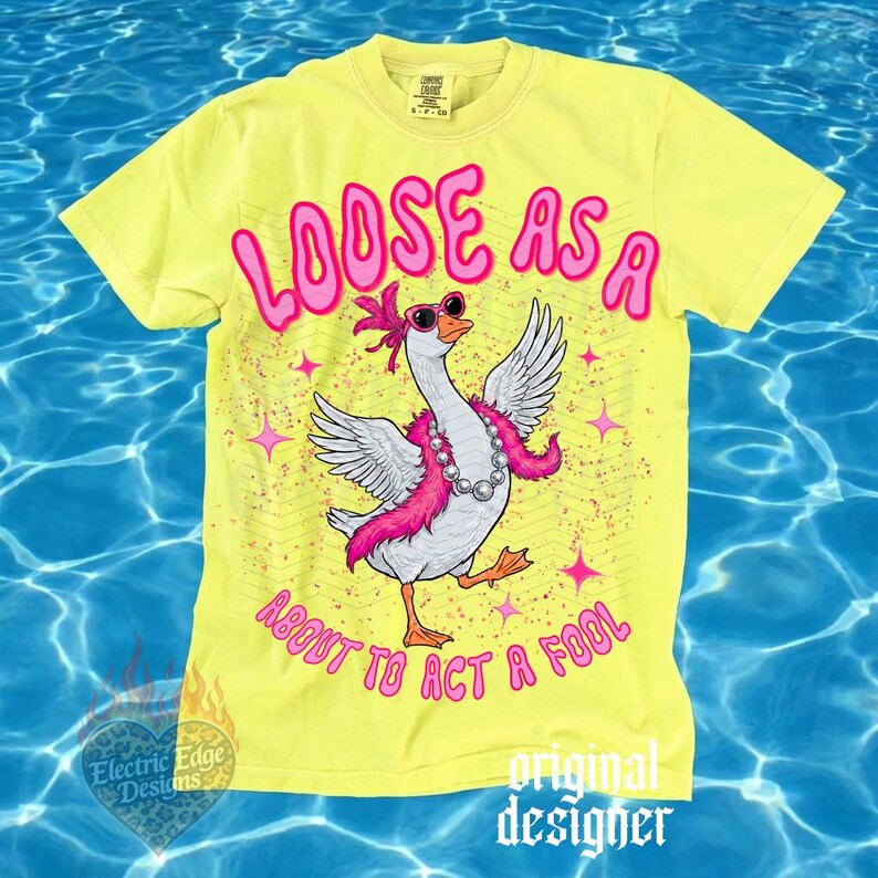 May include: A yellow t-shirt with the text "LOOSE AS A ABOUT TO ACT A FOOL" in pink. The shirt features a cartoon goose wearing sunglasses and a pink boa. The design includes pink stars and a zigzag pattern.