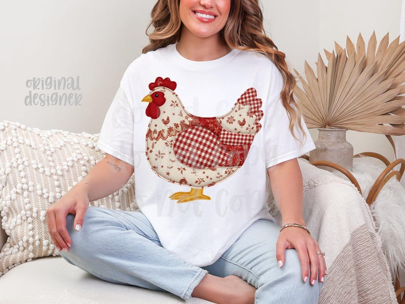 May include: White t-shirt with a large chicken design. The chicken is made up of red, white, and beige fabric patterns, with a red comb and yellow feet. The words "original designer" are visible on the shirt.