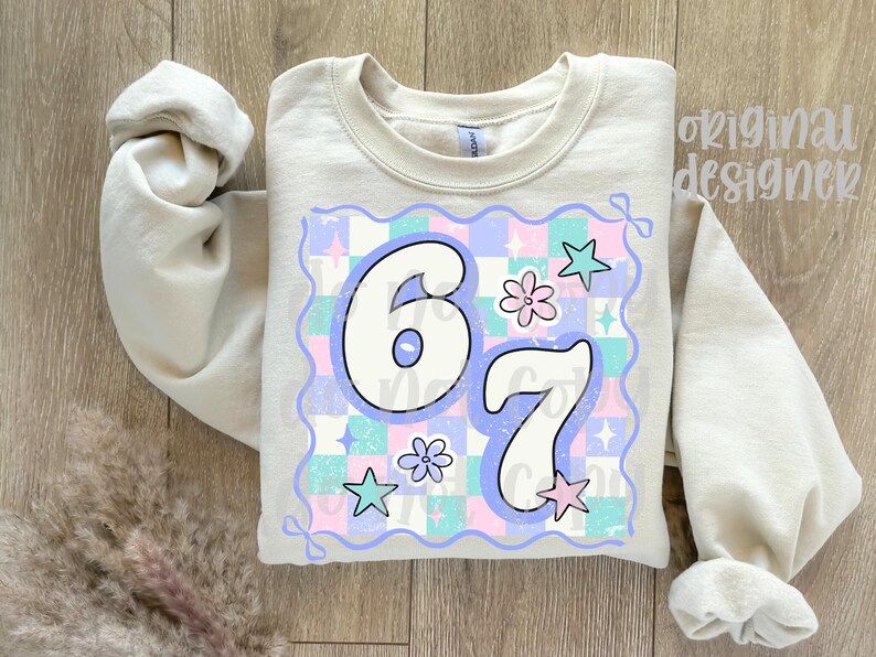 May include: A beige sweatshirt with the number "67" in a retro font, set against a pastel checkered background with stars and flowers. The words "original designer" are printed on the top right.