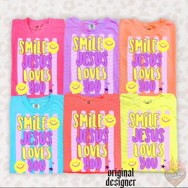 May include: Six colorful t-shirts with the text "SMILE JESUS LOVES YOU" in a playful font. Each shirt features a smiley face graphic and a star. The shirts are in shades of pink, purple, orange, blue, coral, and yellow.
