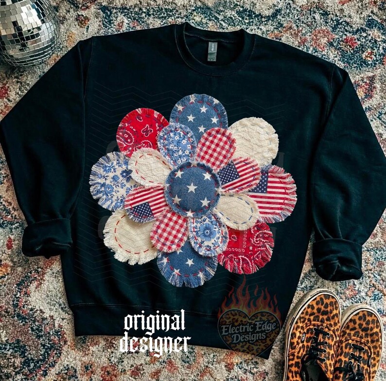 May include: A dark green sweatshirt featuring a large flower design made of fabric patches in red, white, and blue patterns. The flower includes stars, stripes, and American flag motifs. The text "original designer" is at the bottom.