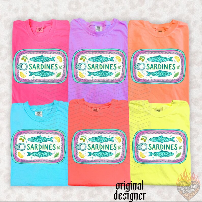 May include: Six colorful t-shirts, each with a unique hue, are displayed. Each shirt features a graphic of a sardine can with a fish illustration, the word "SARDINES", and decorative elements. The shirts are in shades of pink, purple, orange, blue, coral, and yellow.
