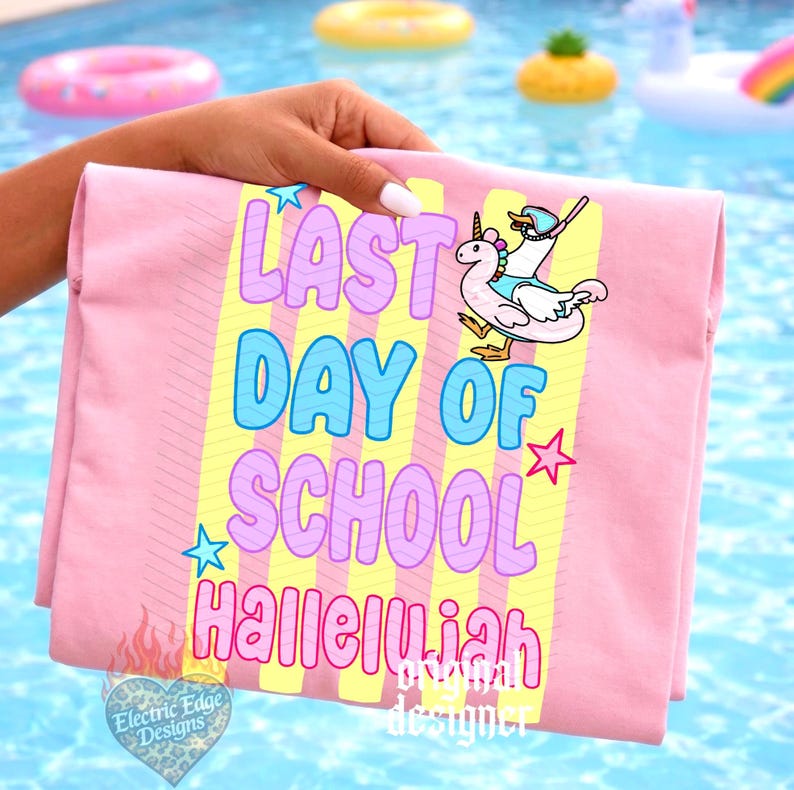 Puede incluir: Una toalla de playa rosa con el texto "LAST DAY OF SCHOOL HALLELUJAH" en un dise&ntilde;o colorido. Tambi&eacute;n se presenta un unicornio de dibujos animados montando un flotador de cisne. La toalla se sostiene contra un fondo de piscina.