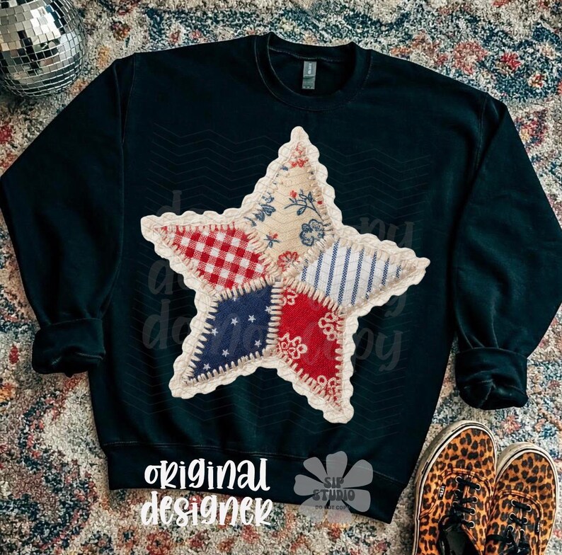 May include: A navy blue sweatshirt featuring a large, patchwork star design. The star is composed of various fabric patterns in red, white, and blue. The words "original designer" are printed at the bottom.