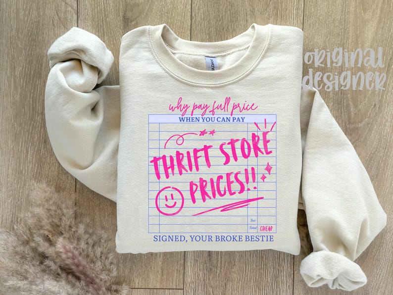 May include: Cream-colored sweatshirt with the text "Why pay full price when you can pay Thrift Store Prices!!" in pink. The design includes a smiley face and the words "Signed, your broke bestie."