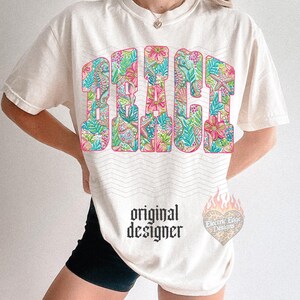 May include: Cream-colored t-shirt with the word "BEACH" in large, floral-patterned letters. The design incorporates seahorses and tropical flowers in pink, green, and blue. The text "original designer" is printed below the main design.
