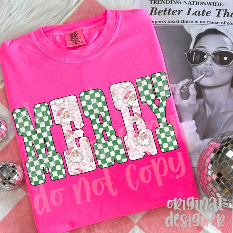 May include: A bright pink t-shirt with the words "MERRY BABY" in a green and white checkered pattern and Santa Claus faces. The text "do not copy" is below the main text. The shirt is a Comfort Colors brand.