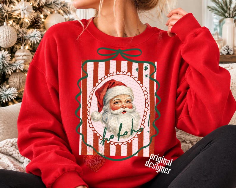 May include: A bright red crewneck sweatshirt featuring a central graphic of a vintage-style Santa Claus face inside a scalloped oval frame. The background of the graphic has vertical red and white stripes, and the text Ho ho ho! is written in green.