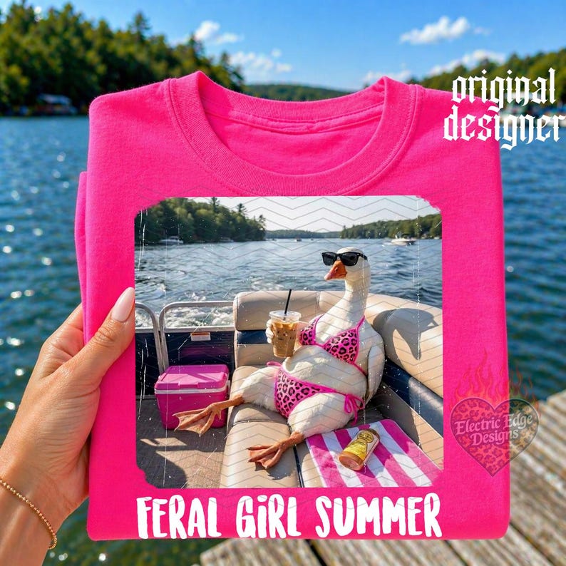 May include: A hot pink t-shirt featuring a graphic of a goose wearing sunglasses and a bikini, holding a drink, and sitting on a boat. The text "FERAL GIRL SUMMER" is at the bottom.