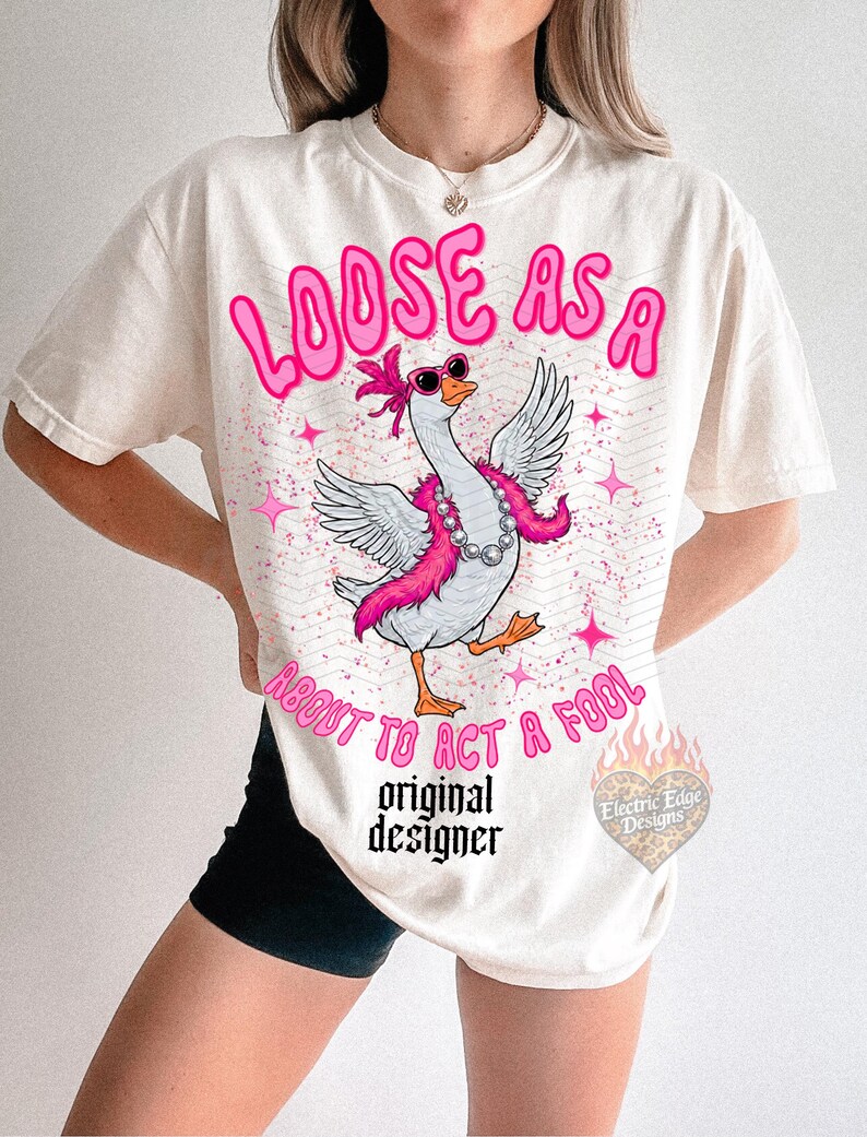 May include: Off-white t-shirt featuring a goose graphic with sunglasses and a pink boa. The text "LOOSE AS A ABOUT TO ACT A FOOL" is above the goose. The words "original designer" are below the goose.