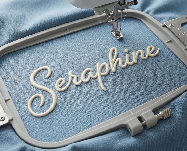 3D puff embroidery font stitched on fabric hoop displaying raised puff texture and cursive design, high quality digital embroidery alphabet files for machine embroidery including BX, PES, DST, EXP, JEF and more, perfect for personalization and unique craft projects.