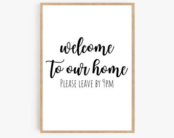 May include: A white framed print with black text that reads "welcome to our home" and "PLEASE LEAVE BY 9PM".