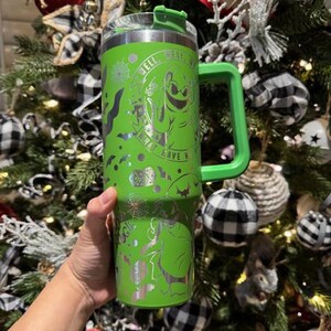 May include: Green stainless steel travel mug with a black and white design featuring a ghost and the text "What have you got to lose? Well..."