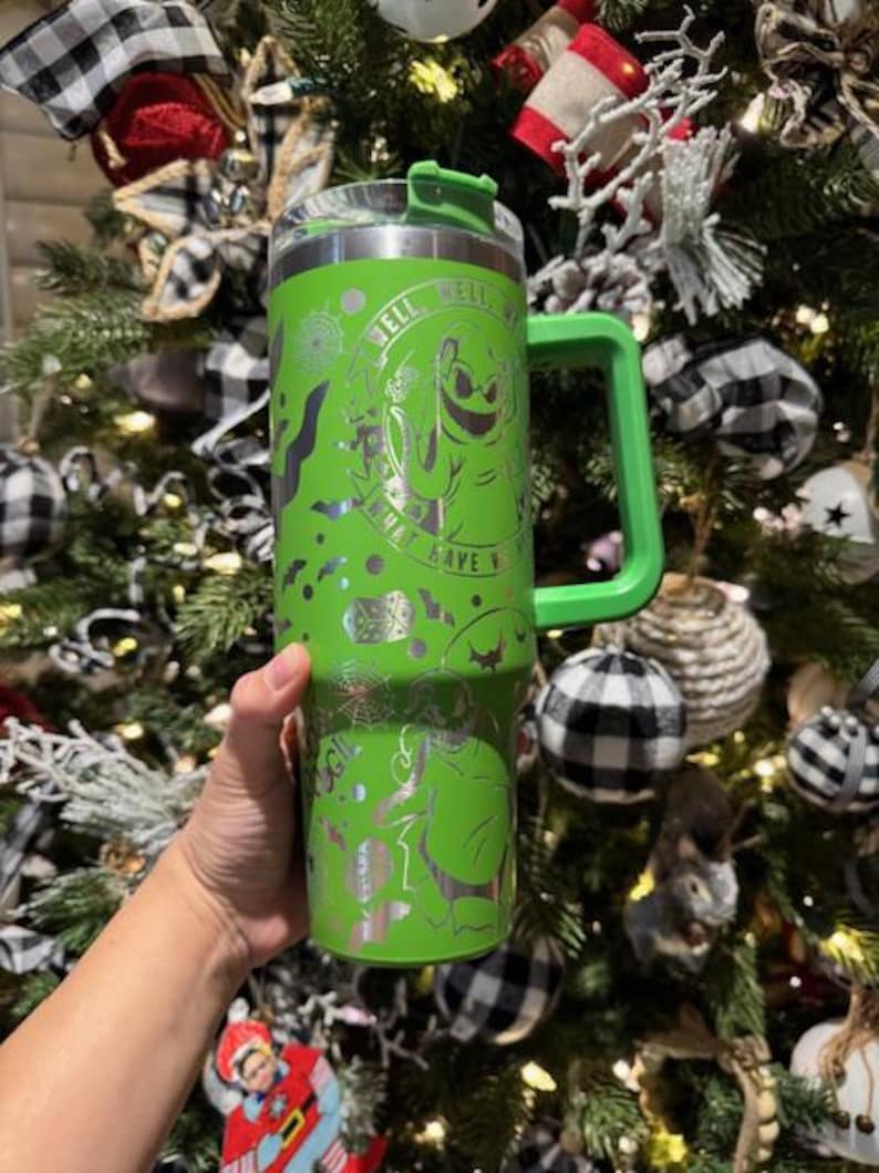 May include: Green stainless steel travel mug with a black and white design featuring a ghost and the text "What have you got to lose? Well..."