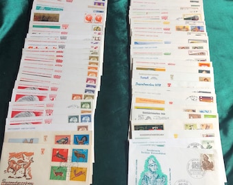 May include: A collection of vintage first day covers featuring stamps from Germany. The covers are in various colors and feature different designs, including a stamp with a picture of a bird, a stamp with a picture of a mountain, and a stamp with a picture of a building. The covers are in good condition and would be a great addition to any stamp collection.