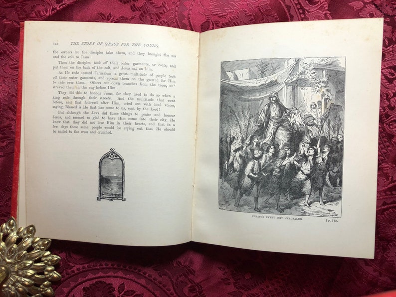 May include: A black and white illustration of Jesus riding a donkey into Jerusalem. People are waving palm branches and cheering. The text "JESUS ENTERS INTO JERUSALEM" is at the bottom of the image.