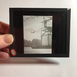 May include: A black and white photograph of the first successful heavier-than-air flying machine. The photograph was taken at the moment of the groundbreaking flight. The text on the image reads: "1st.  First successful heavier-than-air flying machine. A photograph taken at the moment of the groundbreaking flight. May 6, 1908."