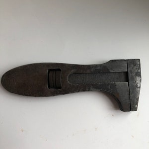May include: A black adjustable wrench with a wooden handle. The wrench has a metal adjustment knob and the text "L.E.F.F.E." is visible on the side.