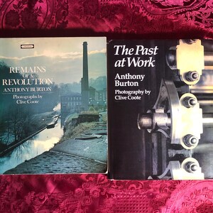 May include: Two hardback books. The first, "Remains of a Revolution" by Anthony Burton, shows a landscape with a tall chimney. The second, "The Past at Work" by the same author, features a close-up of industrial machinery.