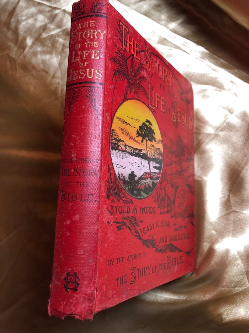 May include: Red hardcover book titled "The Story of the Life of Jesus" with a sunset scene on the cover. The book is written in simple words for easy reading and understanding. It is by the author of "The Story of the Bible."