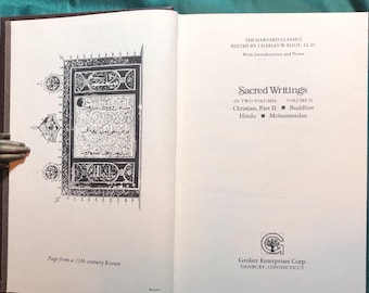 May include: A page from a 13th century Koran, featuring intricate calligraphy in black ink on a white background. The page is framed by a decorative border.