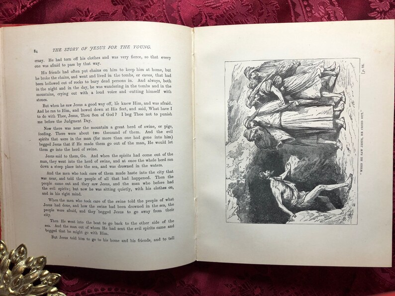 May include: A black and white illustration of a scene from the Bible. Jesus is standing in the center of the image, with a group of people standing behind him. The people are looking at Jesus with fear and awe. The text "The Gad Are Now In The Swine." is printed in the bottom right corner of the image.