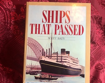 May include: A book titled "Ships That Passed: The Glorious Era of Travel to Australia and New Zealand" by Scott Baty. The cover features a black and white ship sailing under a bridge.