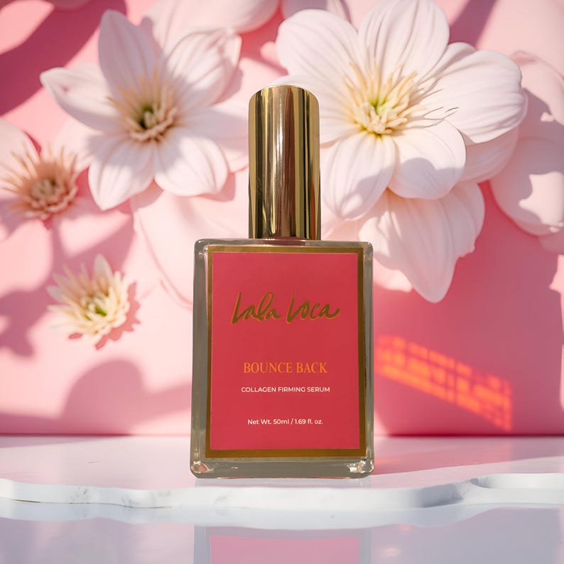May include: A clear glass bottle of Lala Voca Bounce Back Collagen Firming Serum with a gold cap and a red label. The label features gold text and the bottle is set against a pink floral background. The bottle contains 50ml / 1.69 fl. oz. of product.