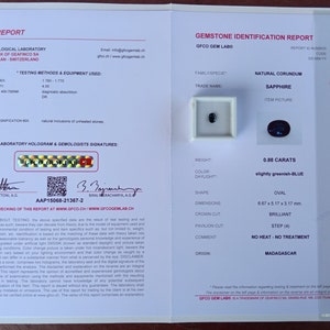 May include: A gemstone identification report for a 0.88 carat, slightly greenish-blue sapphire. The report details the stone's weight, color, shape, dimensions, and origin, which is Madagascar. The report is from GFCO Gem Lab, a trademark of Geafinco SA, Switzerland.