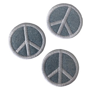 May include: Three gray peace sign embroidered patches with white stitching.