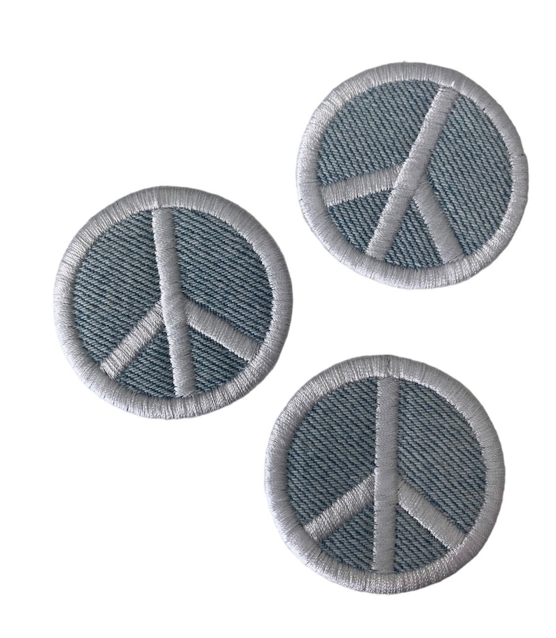 May include: Three gray peace sign embroidered patches with white stitching.