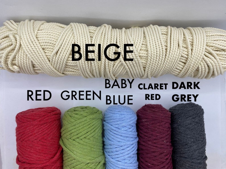 May include: A selection of colorful macrame cords. The top cord is beige, with the word "BEIGE" above it. Below are spools of red, green, baby blue, claret red, and dark grey cords. The colors are labeled with their names.