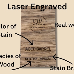 A collection of stained wood sample swatches arranged in a fan layout, each labeled with the stain color and wood type. Swatches include shades like Sedona, Cherry, Dark Walnut, Ebony, Slate, Red Mahogany, and Golden Oak, all engraved with the "CJD Custom Creations" logo. These samples show how different Minwax stains appear on Red Oak wood, helping customers choose the right finish for their woodworking or home improvement projects.