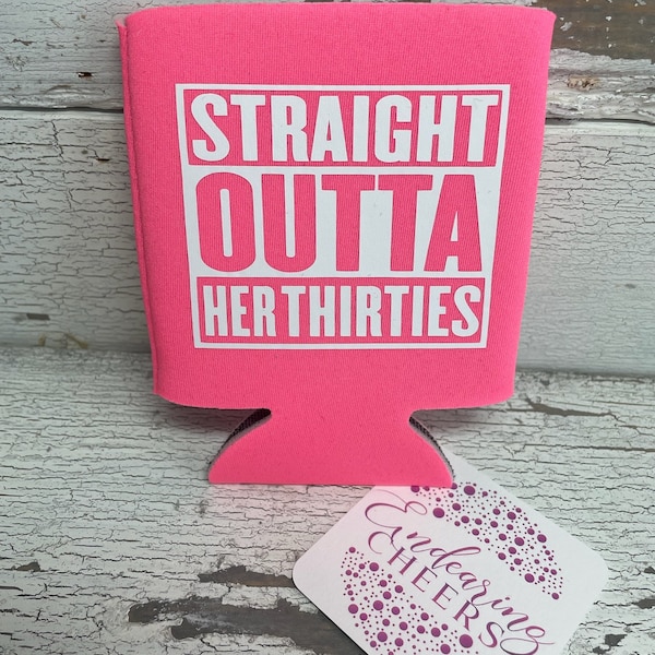 May include: Pink can cooler with the text "STRAIGHT OUTTA HER THIRTIES" in white. 