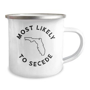 May include: White enamel mug with a black outline of the state of Florida and the text "Most Likely to Secede" around it.