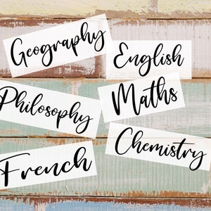 May include: White labels with black cursive text on a rustic wooden background. The labels read: Geography, English, Maths, Chemistry, Philosophy, and French.