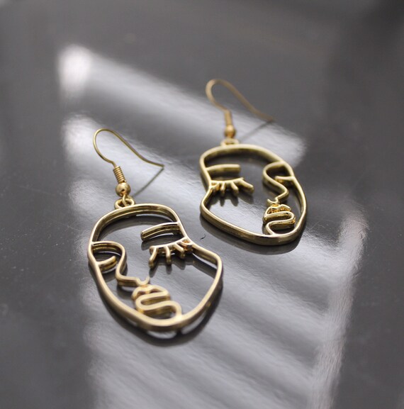 Abstract face outline earrings deals
