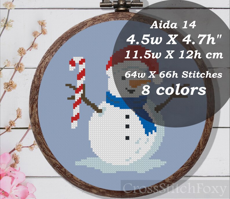 May include: Cross stitch pattern of a snowman holding a candy cane. The pattern is on Aida 14 fabric and measures 4.5 inches wide by 4.7 inches high. The pattern uses 8 colors and is 64 stitches wide by 66 stitches high.