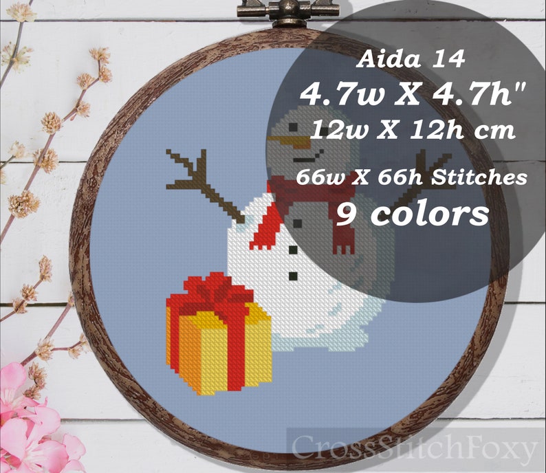 May include: Aida 14 count cross stitch pattern of a snowman holding a gift. The pattern is 4.7 inches wide by 4.7 inches high, or 12 cm wide by 12 cm high. It uses 9 colors and requires 66 stitches wide by 66 stitches high.