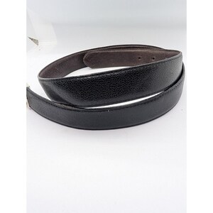 May include: A set of three ceramic mugs with a speckled, matte finish. The mugs are in shades of gray, white, and black. Each mug has a simple, modern design, suitable for coffee or tea. The mugs are stacked on top of each other.