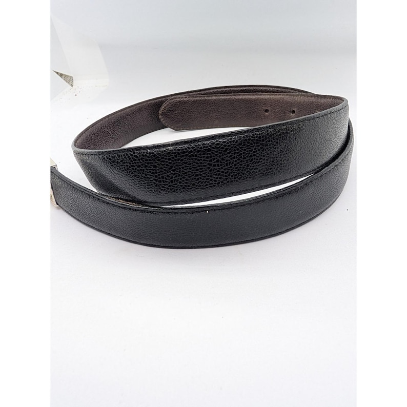 May include: A set of three ceramic mugs with a speckled, matte finish. The mugs are in shades of gray, white, and black. Each mug has a simple, modern design, suitable for coffee or tea. The mugs are stacked on top of each other.